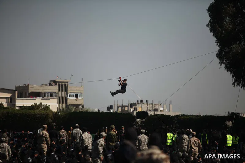 Palestinian youths demonstrate their skills during a graduation ceremony of a military-style camp organized by the Hamas movement in Gaza City on January 29, 2015. Hamas's armed wing organized "Liberation Youths Camps" f...