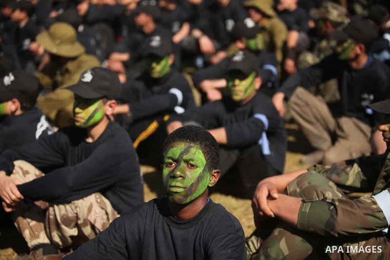 Palestinian youths demonstrate their skills during a graduation ceremony of a military-style camp organized by the Hamas movement in Gaza City on January 29, 2015. Hamas's armed wing organized "Liberation Youths Camps" f...