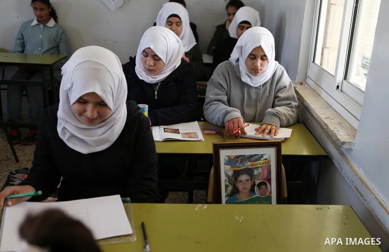 The poster of Malak al-Khatib, a 14-year-old Palestinian girl detained in Israel, is seen on her chair at the school, in the village of Beitin near the West Bank city of Ramallah, on January 29, 2015. The Palestinian sus...