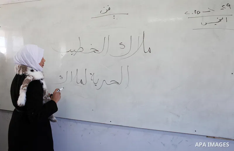 The teacher of Malak al-Khatib, a 14-year-old Palestinian girl detained in Israel, writes on a board "freedom for Malak", at a school in the village of Beitin near the West Bank city of Ramallah, on January 29, 2015. The...
