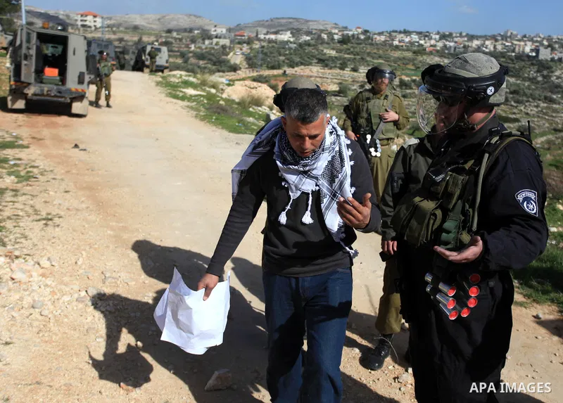 A Palestinian protester argues with an Israeli policeman during a protest against the arrest of 14-year-old girl Malak al-Khatib, in the West Bank village of Bilin west of Ramallah, on January 30, 2015. Malak al-Khatib,...