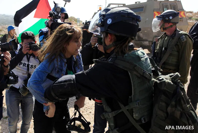 A Palestinian protester clashes with an Israeli policewoman during a protest against the arrest of 14-year-old girl Malak al-Khatib, in the West Bank village of Bilin west of Ramallah, on January 30, 2015. Malak al-Khati...
