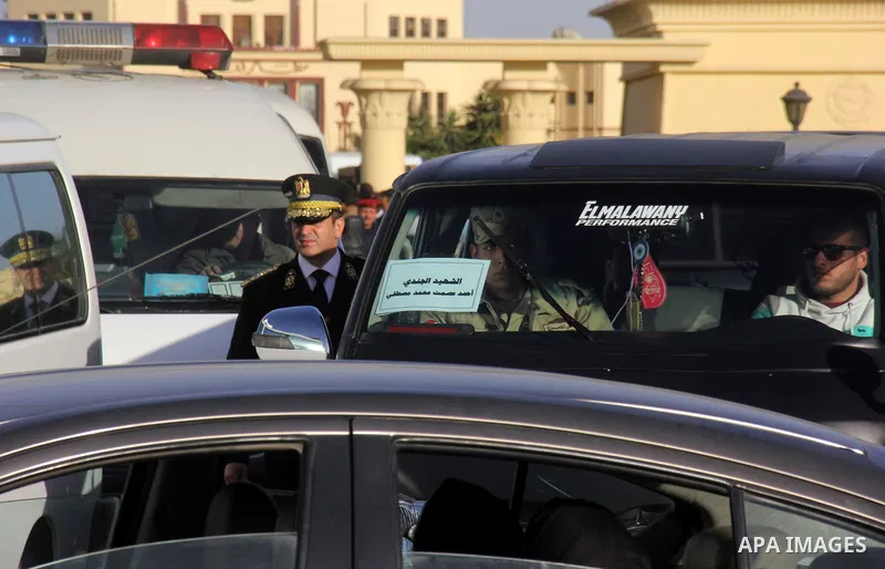 Family members of security forces killed in Sinai on Thursday wait to received the bodies of their relatives, outside Almaza military airport in Cairo, on January 30, 2015. Egyptian officials on Friday raised the death t...