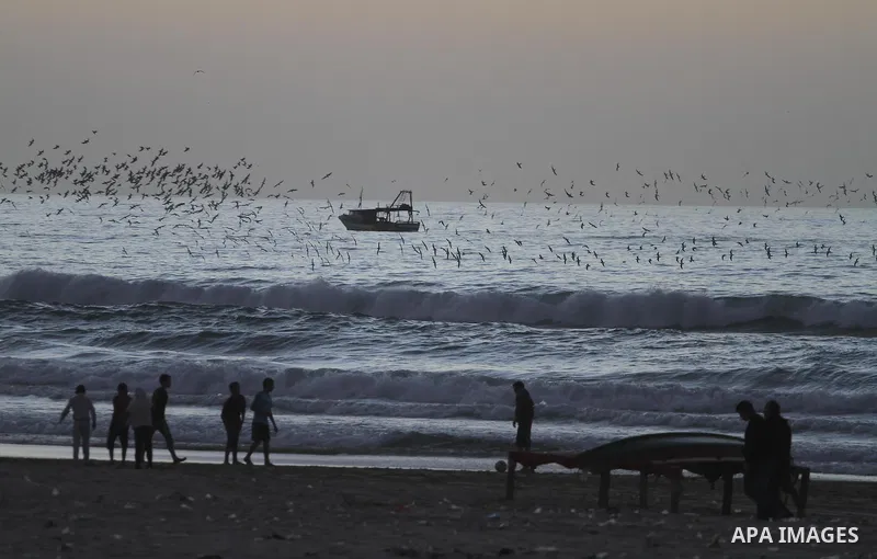 Palestinian children play Football during sunset at the beach of Gaza's sea on January 31, 2015. Photo by Mohammed Asad