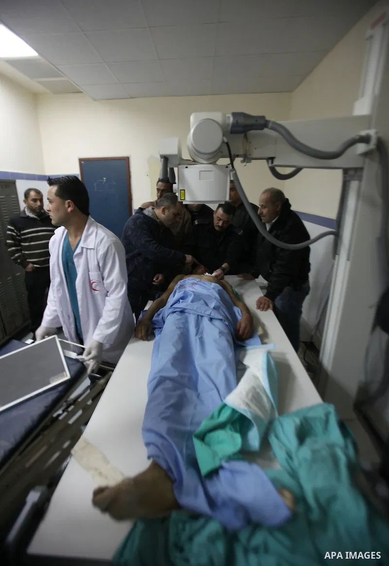 Palestinians gather around the body of Ahmad Najjar, 20, on a hospital bed after he was shot dead by Israeli soldiers in the West Bank village of Burin near Nablus January 31, 2015. Israeli soldiers shot dead Najjar on S...
