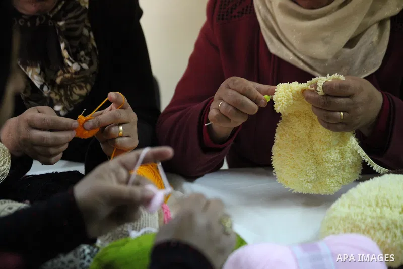 Palestinian women weave wool at Edward Foundation in the West Bank city of Hebron, January 31, 2015. Edward Foundation Marketing products of the Palestinian heritage at the global markets through the display in exhibitio...