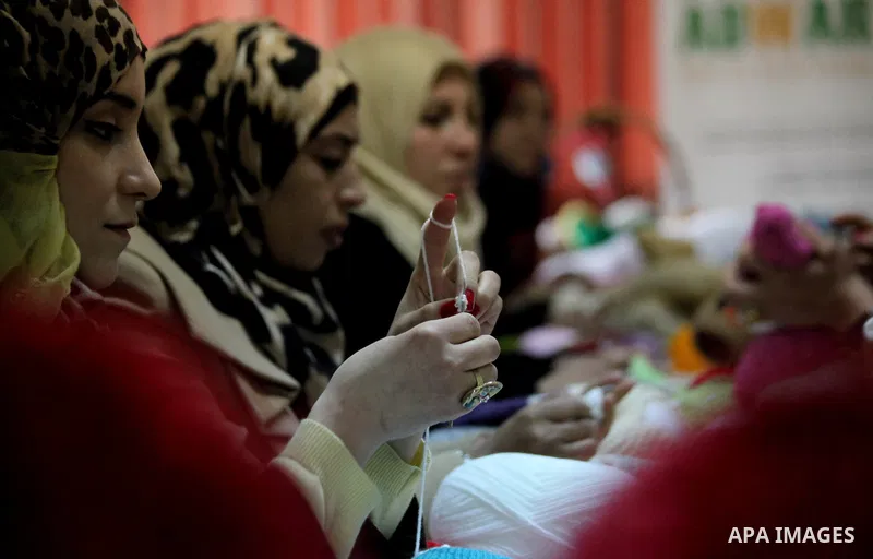 Palestinian women weave wool at Edward Foundation in the West Bank city of Hebron, January 31, 2015. Edward Foundation Marketing products of the Palestinian heritage at the global markets through the display in exhibitio...