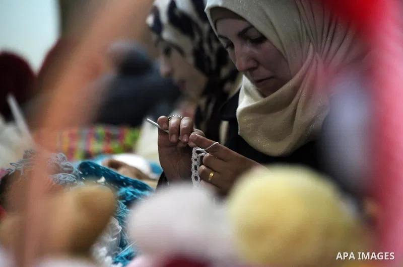 Palestinian women weave wool at Edward Foundation in the West Bank city of Hebron, January 31, 2015. Edward Foundation Marketing products of the Palestinian heritage at the global markets through the display in exhibitio...