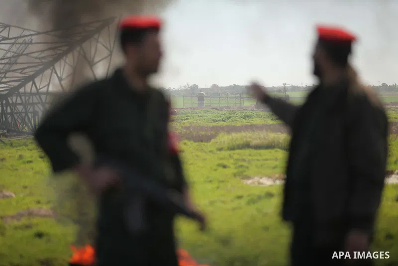 Palestinian policemen stand guard during a protest against the Israeli siege on Gaza strip near the Nahal Oz crossing east of Gaza City on February 1, 2015. Photo by Ashraf Amra