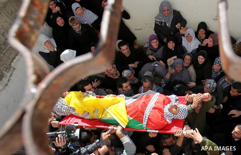 Mourners carry the body of Palestinian Ahmad Najjar, 20, who was shot dead by Israeli soldiers, during his funeral in the West Bank village of Burin near Nablus February 1, 2015. Israeli soldiers shot dead Najjar on Satu...