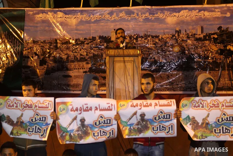 Palestinian supporters of Hamas movement hold banners during a rally against the Egyptian court decision to list Ezz Eddin al-Qassam brigades as a "terrorist group", in Jabalia in the northern Gaza Strip, February 2, 201...