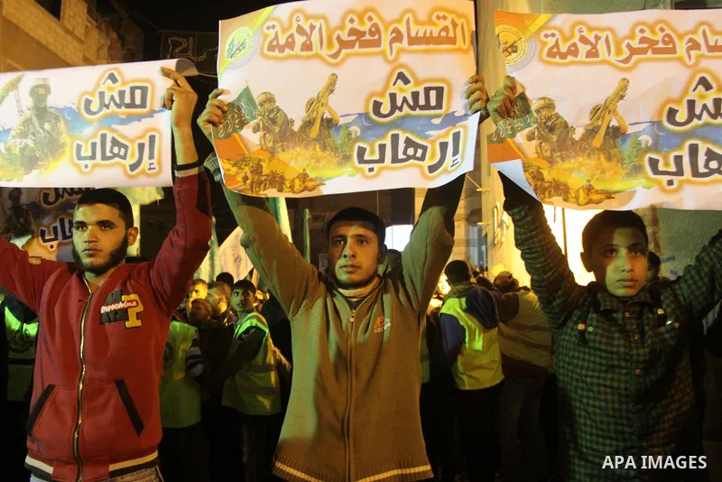 Palestinian supporters of Hamas movement hold banners during a rally against the Egyptian court decision to list Ezz Eddin al-Qassam brigades as a "terrorist group", in Jabalia in the northern Gaza Strip, February 2, 201...