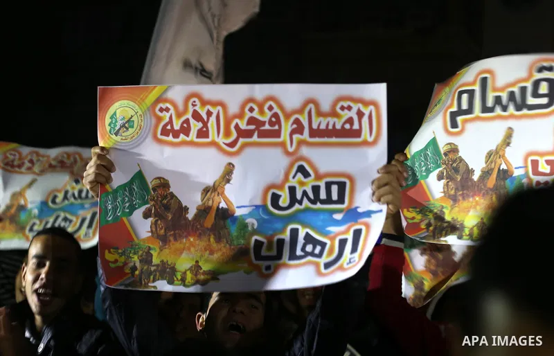 Palestinian supporters of Hamas movement shout slogans during a rally against the Egyptian court decision to list Ezz Eddin al-Qassam brigades as a "terrorist group", in Jabalia in the northern Gaza Strip, February 2, 20...