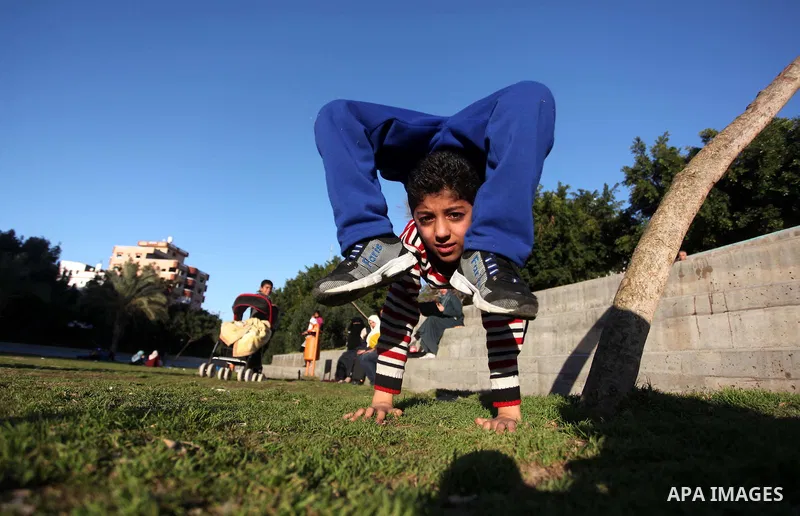 Mohammed El-sheikh, a 11-year-old Palestinian boy, demonstrates his skills at a garden, in Gaza city on February 3, 2015. El-sheikh is a extremely flexible young, who’s been training for only a year without any professio...