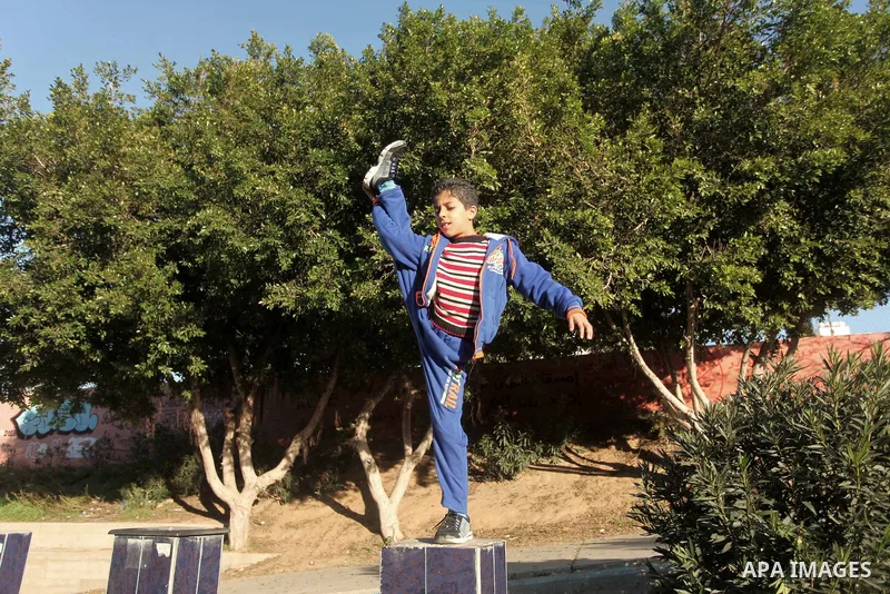 Mohammed El-sheikh, a 11-year-old Palestinian boy, demonstrates his skills at a garden, in Gaza city on February 3, 2015. El-sheikh is a extremely flexible young, who’s been training for only a year without any professio...