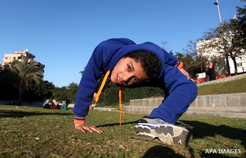 Mohammed El-sheikh, a 11-year-old Palestinian boy, demonstrates his skills at a garden, in Gaza city on February 3, 2015. El-sheikh is a extremely flexible young, who’s been training for only a year without any professio...