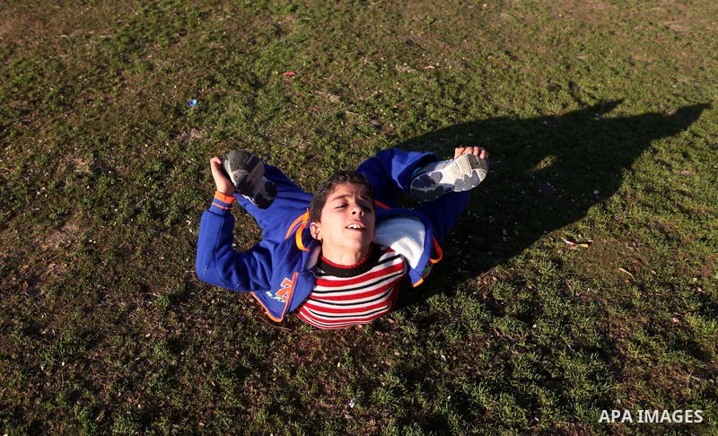 Mohammed El-sheikh, a 11-year-old Palestinian boy, demonstrates his skills at a garden, in Gaza city on February 3, 2015. El-sheikh is a extremely flexible young, who’s been training for only a year without any professio...