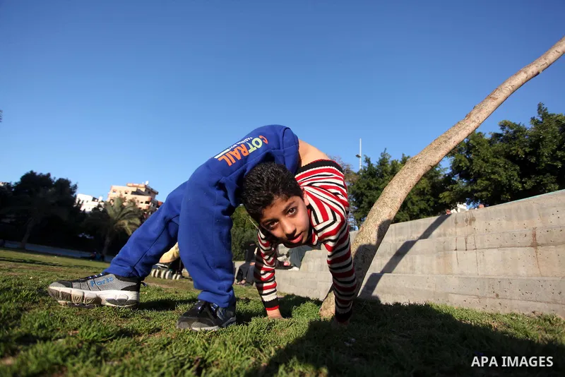 Mohammed El-sheikh, a 11-year-old Palestinian boy, demonstrates his skills at a garden, in Gaza city on February 3, 2015. El-sheikh is a extremely flexible young, who’s been training for only a year without any professio...