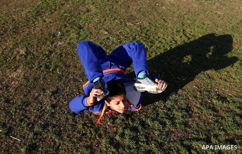 Mohammed El-sheikh, a 11-year-old Palestinian boy, demonstrates his skills at a garden, in Gaza city on February 3, 2015. El-sheikh is a extremely flexible young, who’s been training for only a year without any professio...