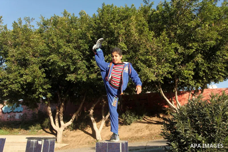 Mohammed El-sheikh, a 11-year-old Palestinian boy, demonstrates his skills at a garden, in Gaza city on February 3, 2015. El-sheikh is a extremely flexible young, who’s been training for only a year without any professio...