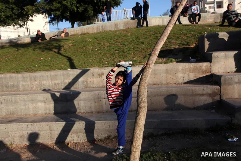 Mohammed El-sheikh, a 11-year-old Palestinian boy, demonstrates his skills at a garden, in Gaza city on February 3, 2015. El-sheikh is a extremely flexible young, who’s been training for only a year without any professio...