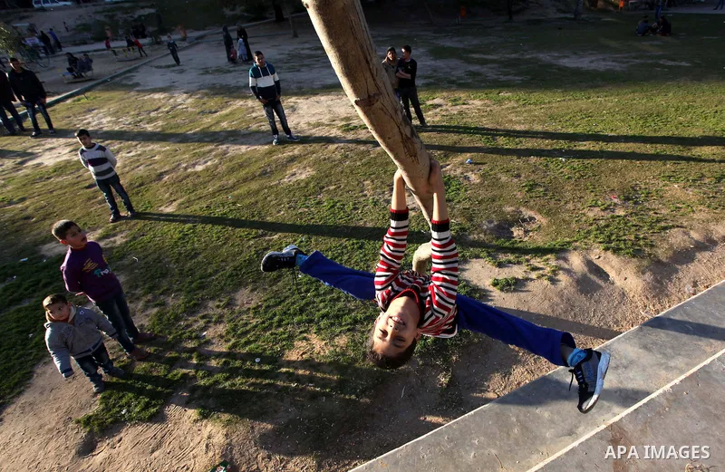 Mohammed El-sheikh, a 11-year-old Palestinian boy, demonstrates his skills at a garden, in Gaza city on February 3, 2015. El-sheikh is a extremely flexible young, who’s been training for only a year without any professio...
