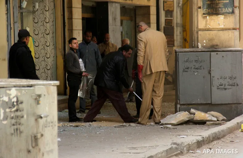 Investigators work on spot next to a shattered shop window in downtown Cairo, Egypt, Feb. 3, 2015. A blast occurred at Talaat Harb square in downtown Cairo, leaving no casualties, an official source at Cairo Security Dir...