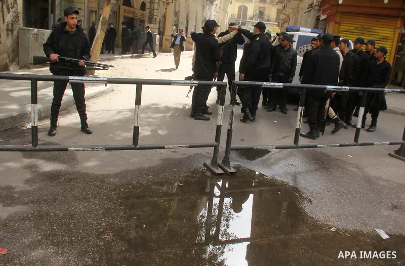 Egyptian soldiers stand guard on the blast site in downtown Cairo, Egypt, Feb. 3, 2015. A blast occurred at Talaat Harb square in downtown Cairo, leaving no casualties, an official source at Cairo Security Directorate wa...