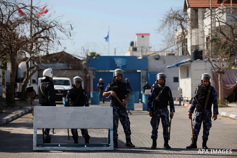 Palestinian policemen stand guard during a protest in front of the headquarters of the United Nations in Gaza city on February 3, 2015 after the UN announced a lack of funds to rebuild the Palestinian territory. Around 2...