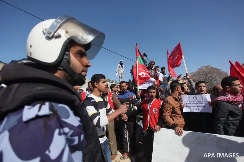Palestinian policemen stand guard during a protest in front of the headquarters of the United Nations in Gaza city on February 3, 2015 after the UN announced a lack of funds to rebuild the Palestinian territory. Around 2...
