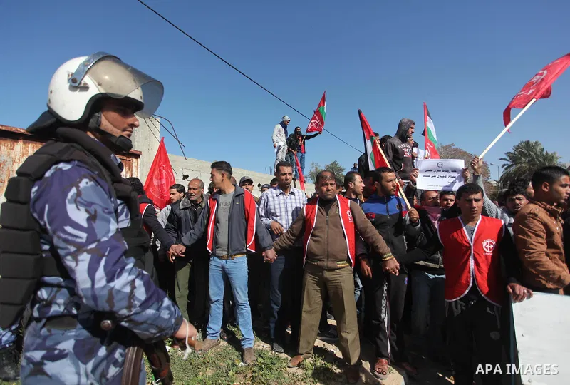 Palestinian policemen stand guard during a protest in front of the headquarters of the United Nations in Gaza city on February 3, 2015 after the UN announced a lack of funds to rebuild the Palestinian territory. Around 2...