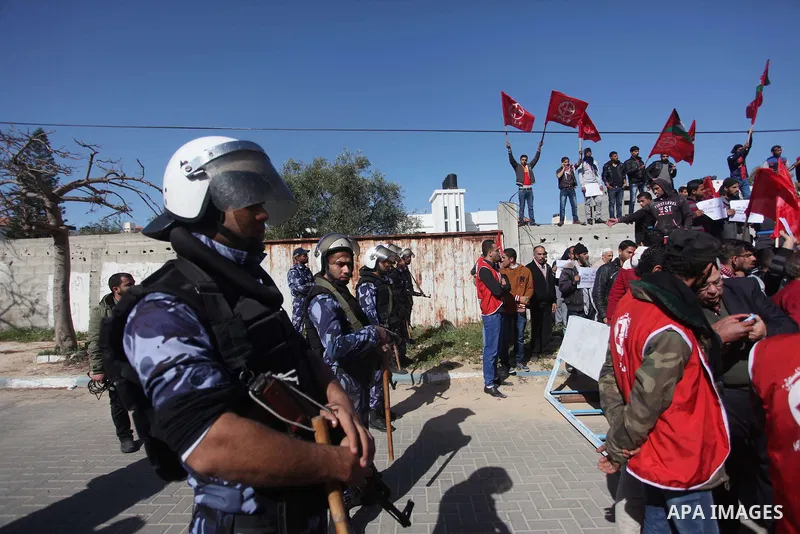Palestinian policemen stand guard during a protest in front of the headquarters of the United Nations in Gaza city on February 3, 2015 after the UN announced a lack of funds to rebuild the Palestinian territory. Around 2...