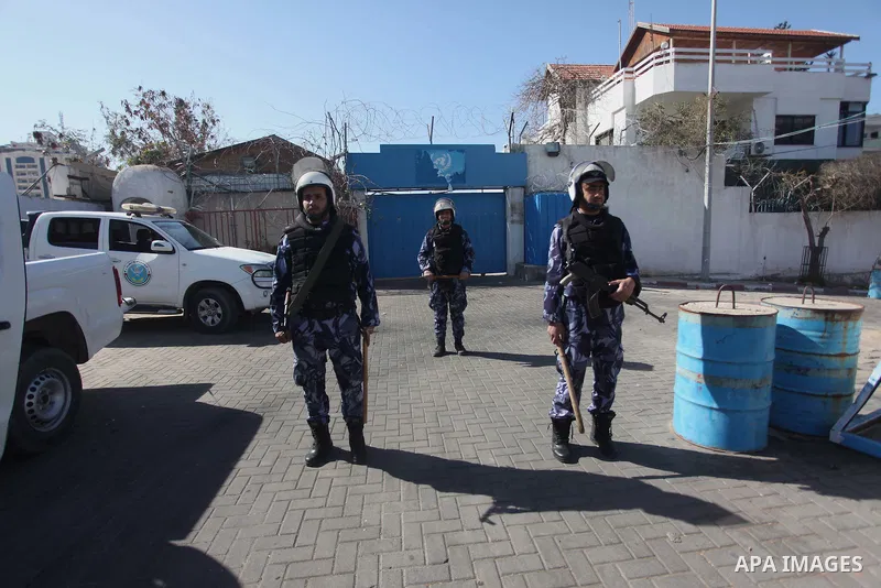 Palestinian policemen stand guard during a protest in front of the headquarters of the United Nations in Gaza city on February 3, 2015 after the UN announced a lack of funds to rebuild the Palestinian territory. Around 2...