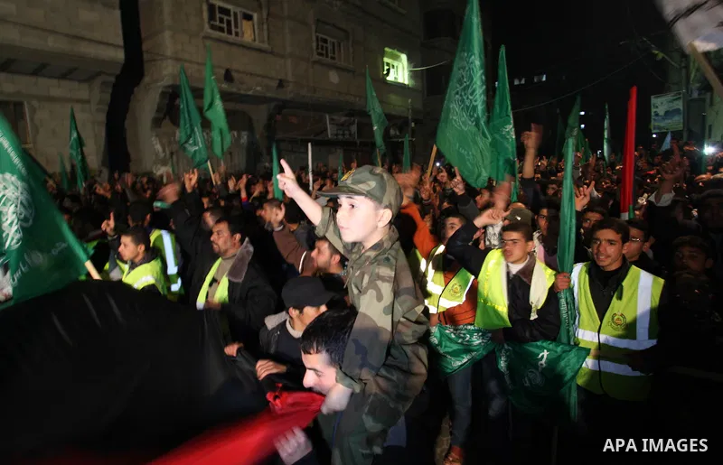 Palestinian supporters of Hamas movement shout slogans during a rally against the Egyptian court decision to list Ezz Eddin al-Qassam brigades as a ''terrorist group'', in Khan Younis in the southern Gaza Strip, February...