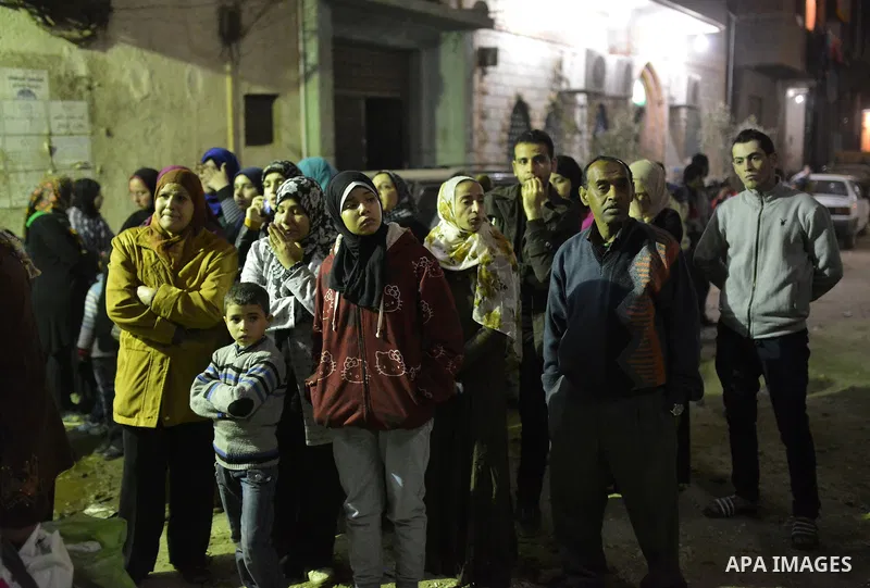 Egyptians look a fire in a perfume factory due to an electrical malfunction in the backup power system in El-Haram district near Cairo, February 3, 2015. Photo by Amr Sayed