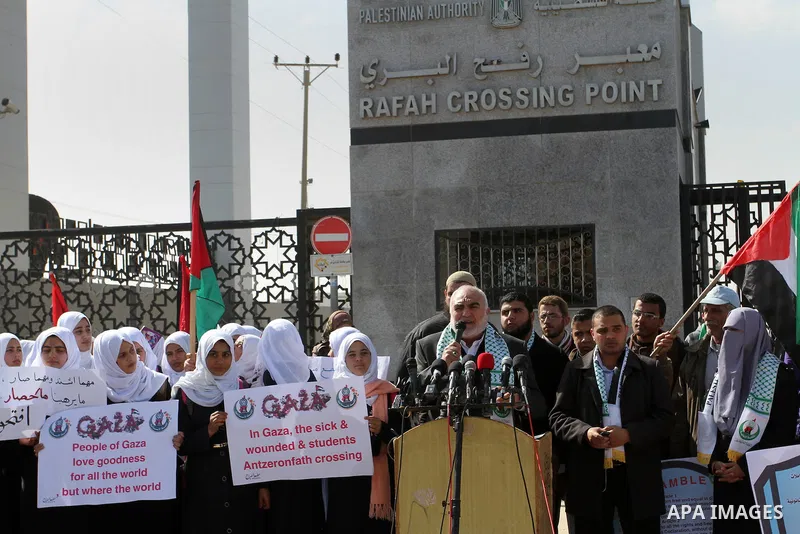 Palestinian students hold banners during a protest outside the Rafah crossing border, demanding the Egyptian authorities for the opening of the crossing, in Rafah in the southern Gaza Strip, February 4, 2015. Photo by Ab...
