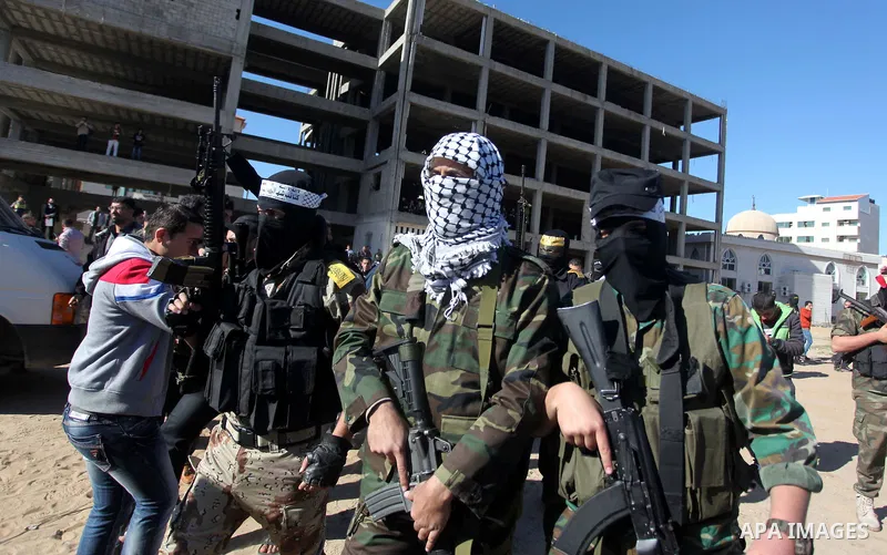 Representatives of various Palestinian armed factions leave after holding a news conference to condemn the decision of an Egyptian court that banned Hamas' armed wing, in Gaza City February 5, 2015. An Egyptian court las...