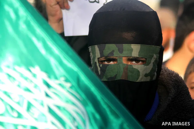 A Palestinian youth looks during a rally to condemn the decision of an Egyptian court to ban the armed wing of Palestinian Islamist movement, near the Rafah border between southern Gaza Strip and Egypt on February 5, 201...