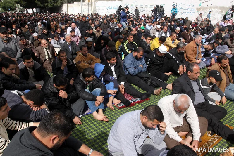 Palestinian Hamas supporters attend Friday prayers outside the Egyptian embassy in a protest to condemn the decision of an Egyptian court to ban the armed wing of Palestinian Islamist movement, in Gaza city on February 6...