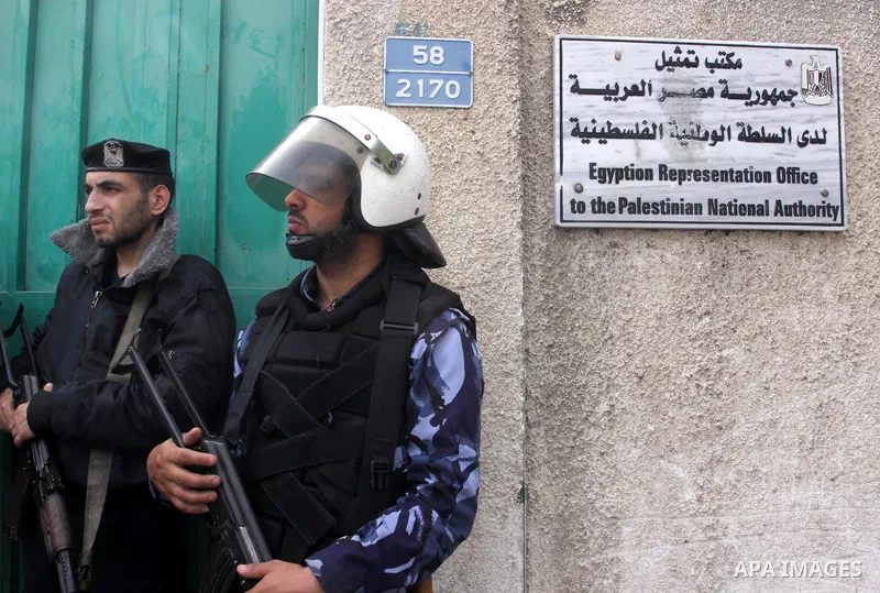 Palestinian security forces stand guard outside the Egyptian embassy during Friday prayers organised by Hamas movement in a protest to condemn the decision of an Egyptian court to ban the armed wing of Palestinian Islami...