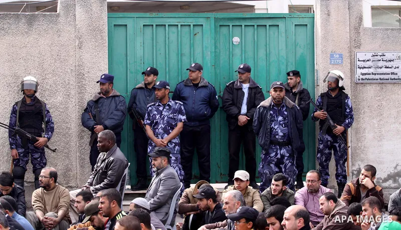 Palestinian security forces stand guard outside the Egyptian embassy during Friday prayers organised by Hamas movement in a protest to condemn the decision of an Egyptian court to ban the armed wing of Palestinian Islami...