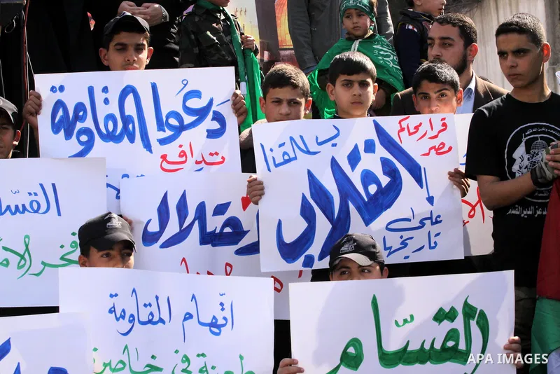 Palestinian Hamas supporters attend Friday prayers outside the Egyptian embassy in a protest to condemn the decision of an Egyptian court to ban the armed wing of Palestinian Islamist movement, in Gaza city on February 6...