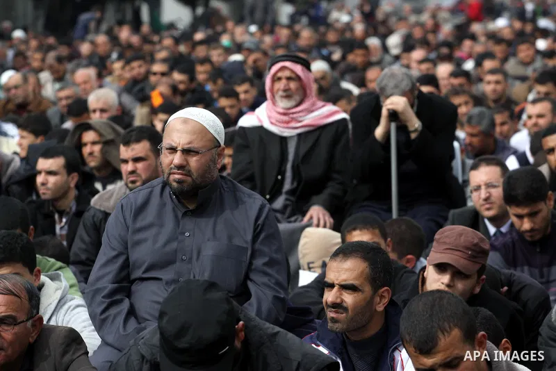 Palestinian Hamas supporters attend Friday prayers outside the Egyptian embassy in a protest to condemn the decision of an Egyptian court to ban the armed wing of Palestinian Islamist movement, in Gaza city on February 6...