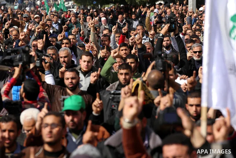 Palestinian Hamas supporters attend Friday prayers outside the Egyptian embassy in a protest to condemn the decision of an Egyptian court to ban the armed wing of Palestinian Islamist movement, in Gaza city on February 6...