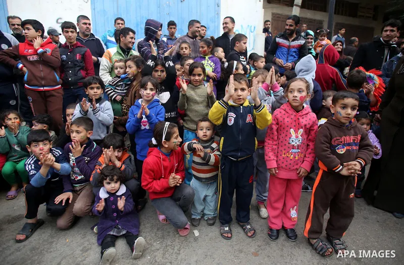Palestinian children attend a street game organised by volunteers of the Friday of Joy Initiative, in al-Shati refugee camp, in Gaza city, February 6, 2015. Ten Palestinian volunteers organise street games, painting and...