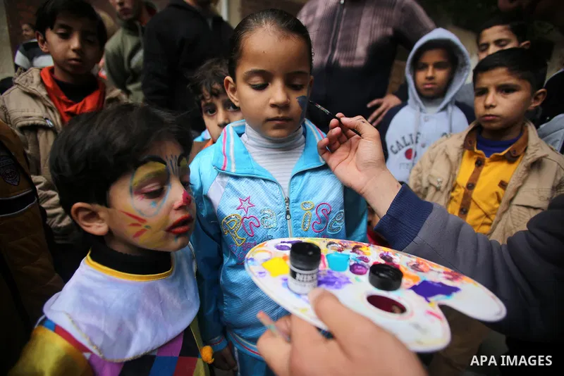 A Palestinian boy get his face painted during a street game organised by volunteers of the Friday of Joy Initiative, in al-Shati refugee camp, in Gaza city, February 6, 2015. Ten Palestinian volunteers organise street ga...