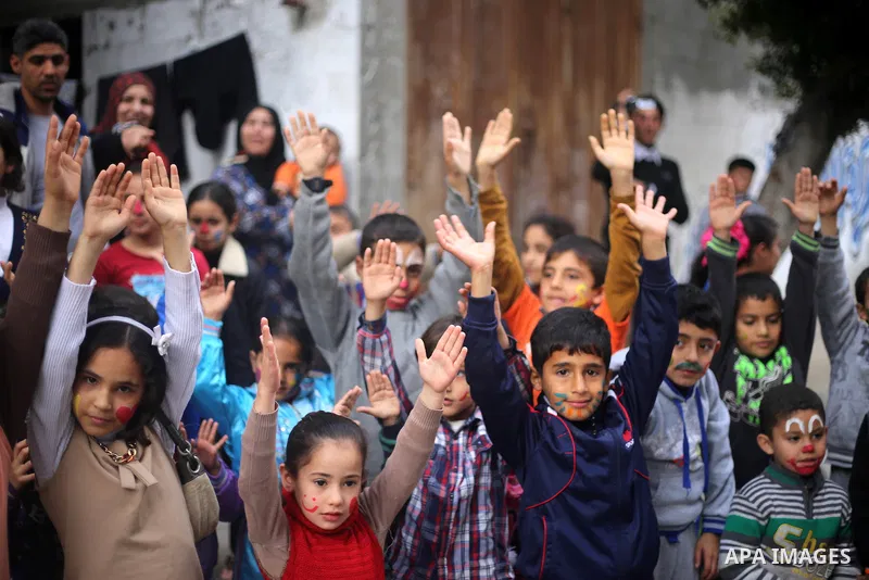 Palestinian children attend a street game organised by volunteers of the Friday of Joy Initiative, in al-Shati refugee camp, in Gaza city, February 6, 2015. Ten Palestinian volunteers organise street games, painting and...