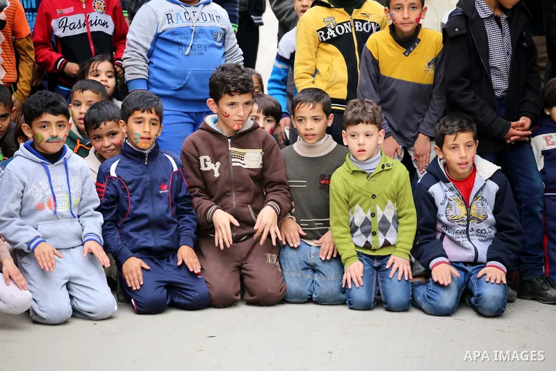 Palestinian children attend a street game organised by volunteers of the Friday of Joy Initiative, in al-Shati refugee camp, in Gaza city, February 6, 2015. Ten Palestinian volunteers organise street games, painting and...