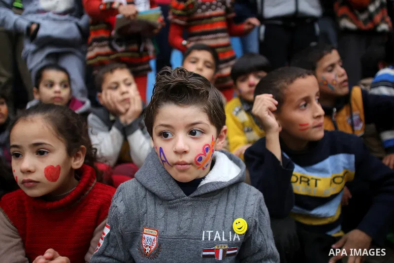 Palestinian children attend a street game organised by volunteers of the Friday of Joy Initiative, in al-Shati refugee camp, in Gaza city, February 6, 2015. Ten Palestinian volunteers organise street games, painting and...