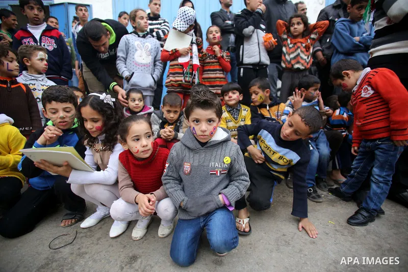 Palestinian children attend a street game organised by volunteers of the Friday of Joy Initiative, in al-Shati refugee camp, in Gaza city, February 6, 2015. Ten Palestinian volunteers organise street games, painting and...